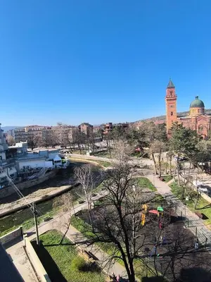a view of a park with a building in the background at Mina Lux in Paraćin