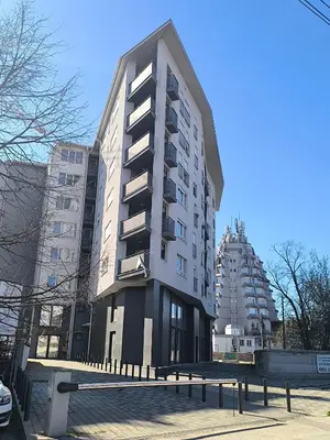 a tall apartment building with a bench in front of it at Mina Lux in Paraćin