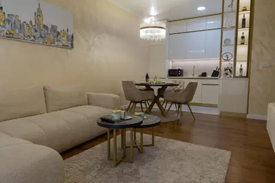 a living room with a couch and a table at Premium Planet Deluxe & SPA in Niš