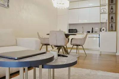 a living room with a table with a laptop on it at Premium Planet Deluxe & SPA in Niš