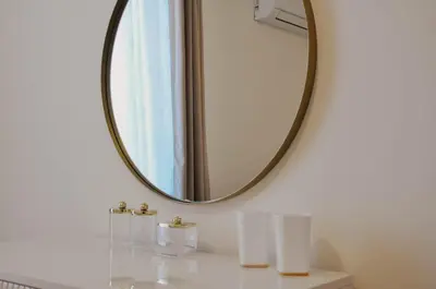a bathroom with a mirror and three white towels at Premium Planet Deluxe & SPA in Niš