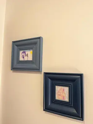 two framed pictures are hanging on a wall at Mars apartman in Vrnjačka Banja