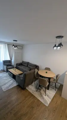 a living room with a couch and a table at Planet Urban Apartment & SPA in Niš