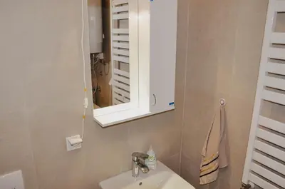 a bathroom with a sink and a mirror at Planet Urban Apartment & SPA in Niš