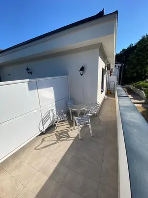 a patio with chairs and a table on a building at Sunshine Lux in Vrnjačka Banja