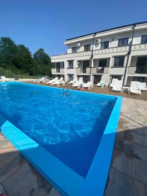 a large swimming pool in front of a building at Sunshine Lux in Vrnjačka Banja