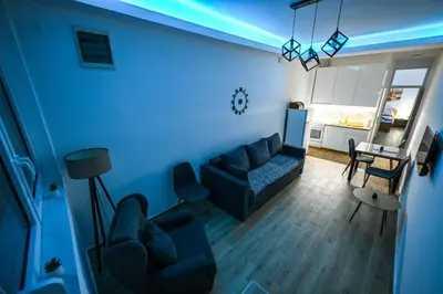 a living room with a couch and a table at STAN na DAN MITIC FREE PARKING in Vranje