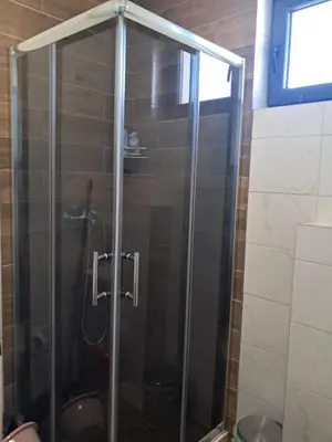 a shower with a glass door in a bathroom at Apartman S&U in Soko Banja