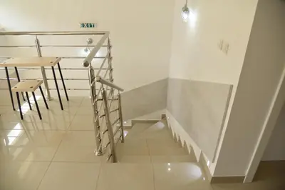 a staircase with a table and a stool in a room at Ribarski Konaci in Ribarska Banja