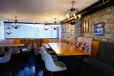 a dining room with a wooden table and chairs at Ribarski Konaci in Ribarska Banja