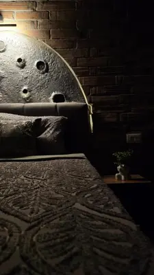 a bedroom with a bed and a brick wall at 