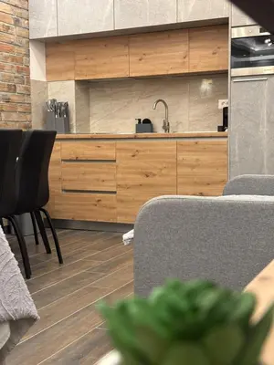 a kitchen with wooden cabinets and a table and chairs at 