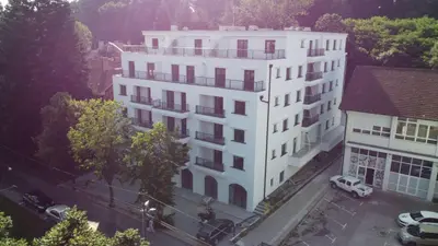 a white building with cars parked in front of it at 