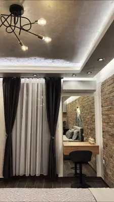 a room with a window and a desk and a ceiling at 