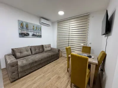 a living room with a couch and a table at Apartman CRYSTAL Vrnjačka Banja in Vrnjačka Banja