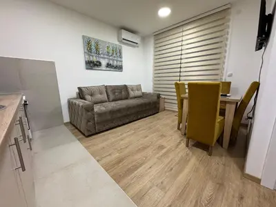 a living room with a couch and a table at Apartman CRYSTAL Vrnjačka Banja in Vrnjačka Banja