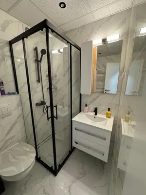 a bathroom with a shower and a sink and a toilet at Apartman CRYSTAL Vrnjačka Banja in Vrnjačka Banja
