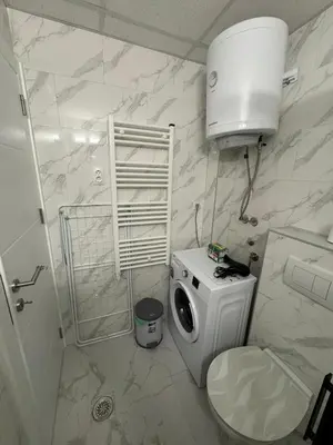 a bathroom with a toilet and a washing machine at Apartman CRYSTAL Vrnjačka Banja in Vrnjačka Banja