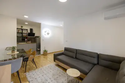 a living room with a couch and a table at Apartman ZVONKO in Vrnjačka Banja