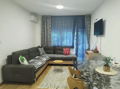 a living room with a couch and a table at Apartman ZVONKO in Vrnjačka Banja