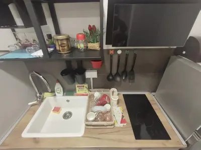 a kitchen with a sink and a counter with utensils at Apartman ZVONKO in Vrnjačka Banja