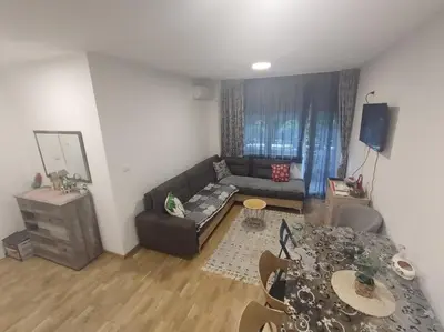 a living room with a couch and a table at Apartman ZVONKO in Vrnjačka Banja