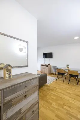 a living room with a couch and a table with chairs at Apartman ZVONKO in Vrnjačka Banja