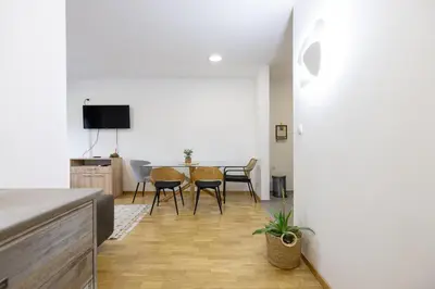 a living room with a table and chairs at Apartman ZVONKO in Vrnjačka Banja