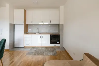 a kitchen with white cabinets and a sink at Apartman STEFAN in Vrnjačka Banja