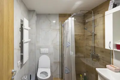 a bathroom with a toilet and a glass shower at Apartman STEFAN in Vrnjačka Banja