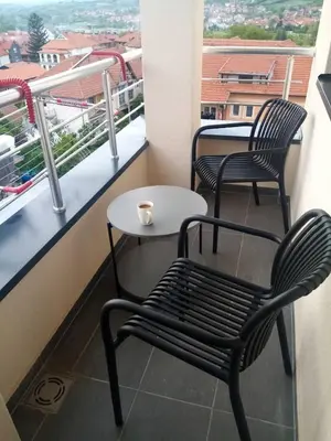 two chairs and a table on a balcony with a view at Moj kutak Sokobanja in Soko Banja