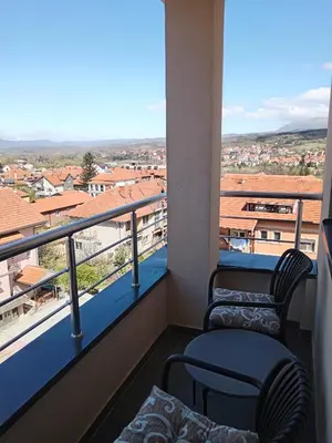 a balcony with two chairs and a view of a city at Moj kutak Sokobanja in Soko Banja