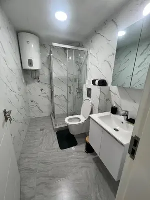 a bathroom with a shower and a toilet and a sink at New Resort Treska, Kopaonik in Kopaonik