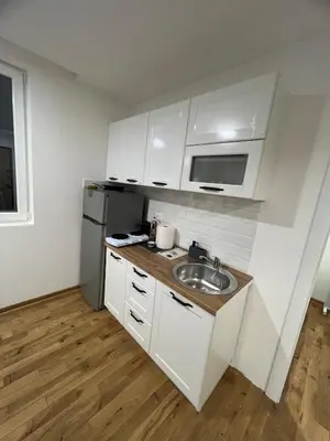 a white kitchen with a sink and a refrigerator at New Resort Treska, Kopaonik in Kopaonik