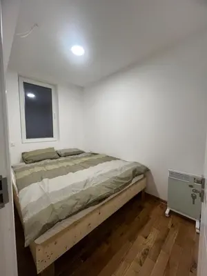 a bedroom with a bed in a room with a window at New Resort Treska, Kopaonik in Kopaonik