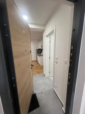 a hallway with a wooden door in a room at New Resort Treska, Kopaonik in Kopaonik