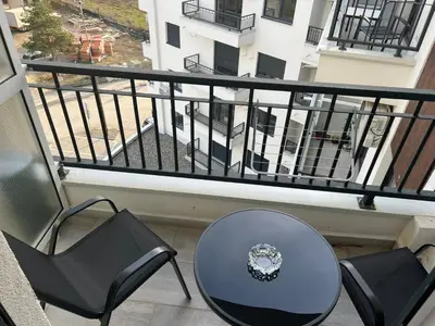 a table and chairs on a balcony with a view at Apartman David in Vrnjci