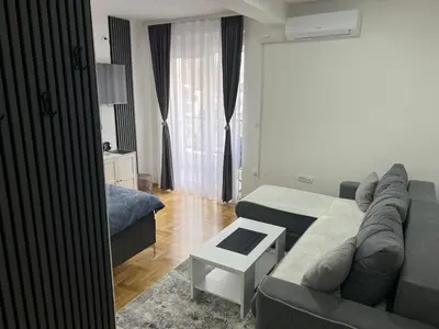 a living room with a couch and a bed at Apartman David in Vrnjci