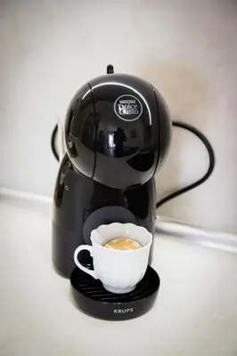 a coffee maker with a cup of coffee at Apartman NN in Vrnjci