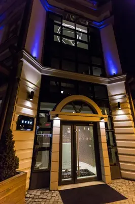 a front door of a building with blue lights at Garni Hotel Eter in Niš