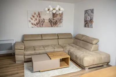 a living room with a couch and a coffee table at Apartmani EMA SL in Vranje