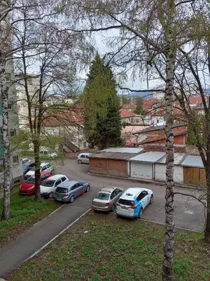 a group of cars parked in a parking lot at Apartman Klinički Centar Niš in Niš