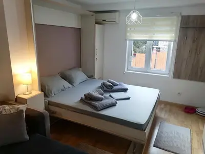 a bedroom with a bed with towels on it at Royal 019 in Vrnjačka Banja