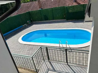 a large swimming pool with a fence around it at Royal 019 in Vrnjačka Banja