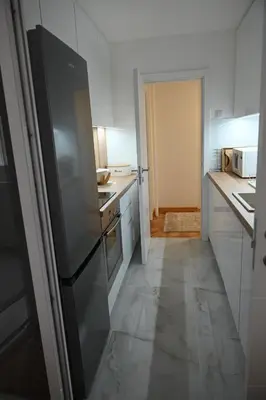 a kitchen with a stainless steel refrigerator in it at Apartman Leskovac 1 in Leskovac