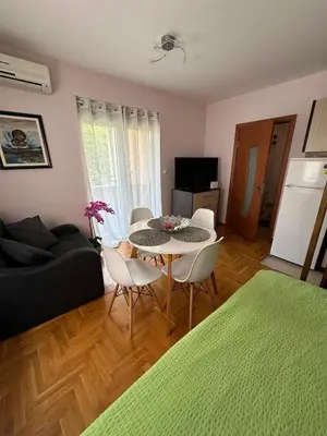 a living room with a table and chairs at EDEM Apartment in Vrnjačka Banja