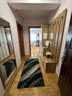 a small room with a mirror and a rug at EDEM Apartment in Vrnjačka Banja