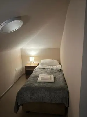 a bedroom with a bed and a table with a lamp at JP Motel Mali Pariz in Bor