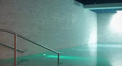 an empty room with a metal handrail and a wall at The Daily Nest in Niš