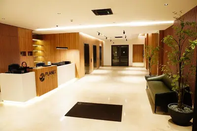an office lobby with a reception desk and a couch at The Daily Nest in Niš